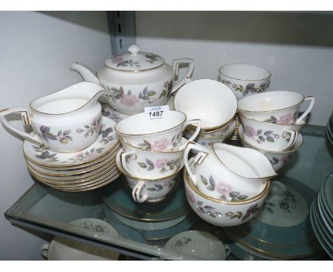 A Royal Worcester ''June Garland'' part Teaset including teapot, nine cups, eight saucers, eleven tea plates, sugar bowls (on