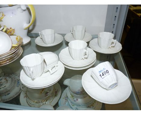 A Paris porcelain part coffee set comprising seven cups and eight saucers, in white with ribbed detail.