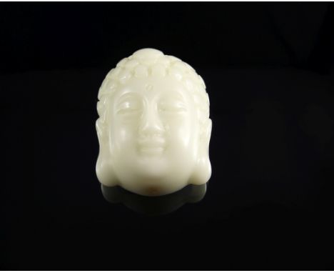 A Chinese pale white jade pendant of Buddha's head, 20th century, 5cm high CONDITION REPORT: overall in good condition, hole 