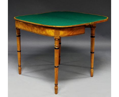 A Regency satinwood games table, circa 1810 with D shaped rosewood crossbanded top and on ring turned tapering legs, 73 x 92 