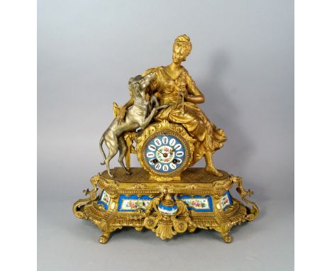 A French gilt and silvered spelter and Sevres style porcelain clock, late 19th century, mounted with a lady and her hound, re