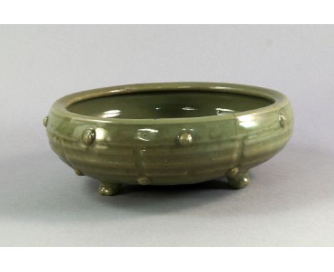 A Chinese celadon censer, Ming Dynasty, moulded with the the eight trigrams of the Ba Gua, on tripod feet, 23cm diameter COND