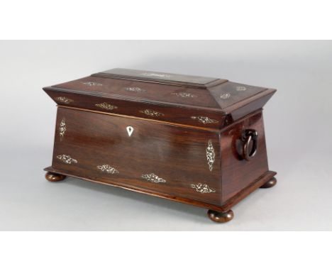 A Victorian rosewood and mother of pearl inlaid tea caddy, of sarcophagus form, with ring handles on bun feet, the interior f