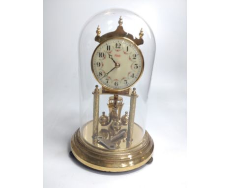 A brass clock under glass dome. 