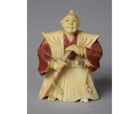 An Early 20th Century Japanese Carved Netsuke in the Form of a Robed Master with Sword in Hand, Decorated with Polychrome Col