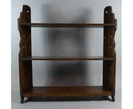 An Edwardian Mahogany Three Tier Wall Mounting Shelf with Pierced Supports, 57cm Wide 