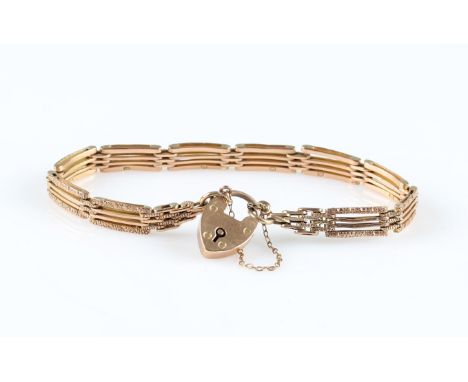 A gate bracelet, each link engraved with repeat design, bracelet stamped 9, with heart padlock clasp, stamped 9c, along with 
