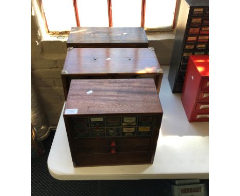 Three wooden multi-drawer chests containing washers, handles, O-rings and other parts and tools.