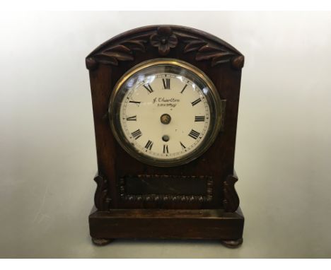 A J Charlton London small bracket clock in rosewood case with a subtle fused movement, with leaf and flower carved relief to 