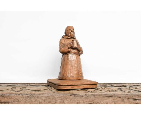 Workshop of Robert Mouseman Thompson (Kilburn): A Carved English Oak Figure of a Merry Monk Newel Post Top, the monk holding 