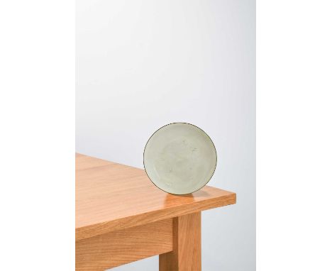 Lucie Rie (1902-1995): A Stoneware Side Plate, circa 1959, covered with an all over white glaze, manganese rim, impressed LR 