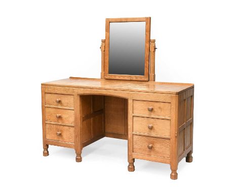 Workshop of Robert Mouseman Thompson (Kilburn): An English Oak Dressing Table, with fixed central pivoting rectangular mirror