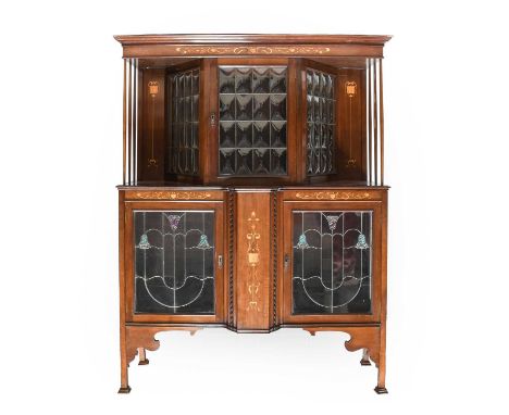 An Art Nouveau Inlaid Mahogany Display Cabinet, the upper section with a stepped cornice above a leaded glaze door and sides,