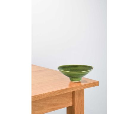 Lucie Rie (1902-1995): A Porcelain Footed Bowl, covered in a green glaze, impressed LR mark,18cm diameter (chip and crack to 