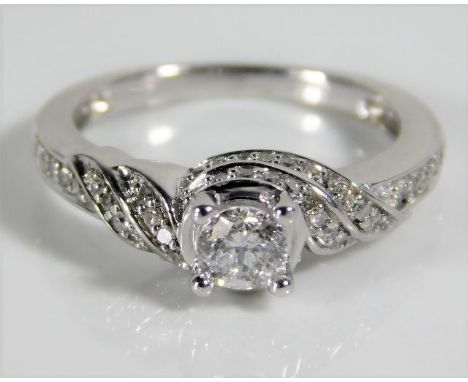 An 18ct white gold ring set with diamonds, centre stone 0.33ct 3g size G