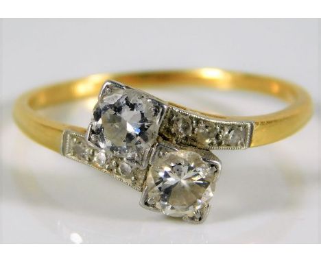 An 18ct gold art deco period diamond crossover ring set with approx. 0.8ct diamonds 2.9g size R/S