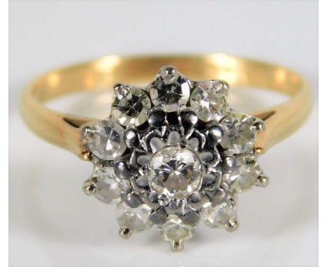 An 18ct gold diamond daisy ring set with approx. 0.77ct diamond