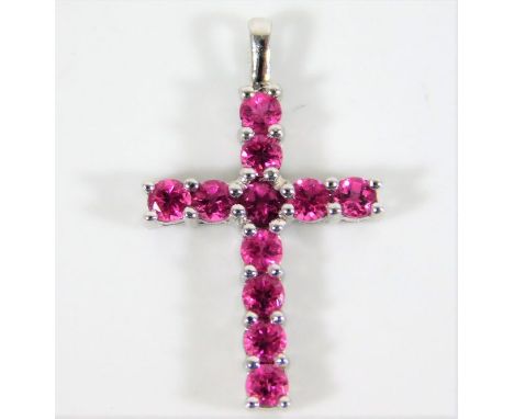 A 9ct white gold cross set with ruby 1.1g