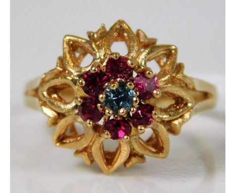 An 18ct rose gold ring set with red &amp; blue paste stones 5.2g size R