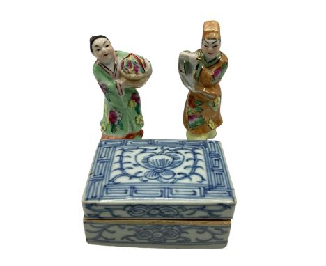 Two Chinese polychrome figures together with a small blue and white ceramic lidded box with gilt calligraphy to interior. 