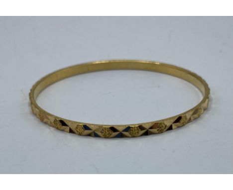 A middle eastern yellow metal bangle with Arabic marks to hoop. 16.7g. 