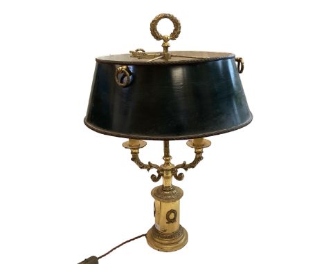 A traditional brass library table lamp with a 3 branch light to a green shade 