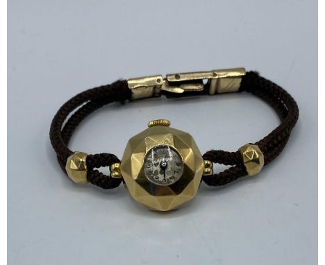 A Garrard and Co 18ct gold hexagonal domed cased ladies cocktail watch on cord strap. 