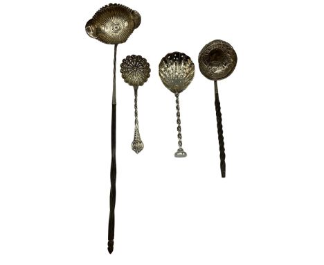 An unmarked white metal coin set toddy ladle with twisted horn/bone handle together with another similar and two unmarked whi