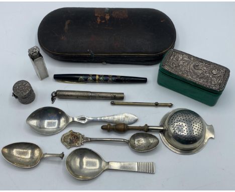 A collection of sterling silver items to include a Danish caddy spoon, a Mappin and Webb silver perfume holder and other item