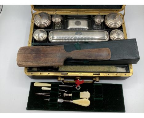 A ladies travelling vanity set marked Paris M-G to lock, near complete with original white metal topped items  brushes etc, 