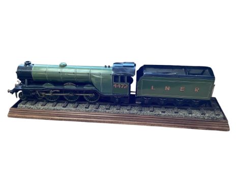 A large Desk top model of The Flying Scotsman Train. 4472 on a naturalistic track base with matching tender. 103cm 