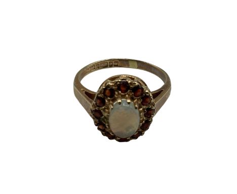 9 ct gold opal and garnet ring central oval opal with a surround of single cut red garnets size K, 2.35 g 