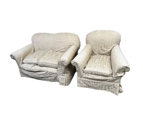A two seater sofa and chair, upholstered in fawn coloured loose covers 