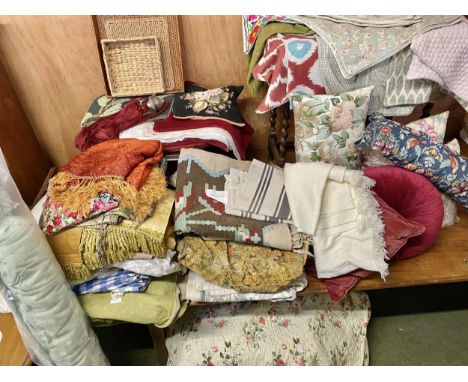 A very sizeable quantity of curtains, material, cushion covers, cushions, bedspread, rugs, baskets etc, all from a good count