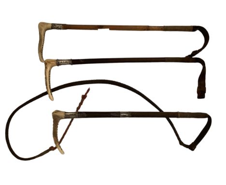 Three hunting whips, with hallmarked silver collars, 1920s/1930 ; one with a thong, all with some wear and some dents 