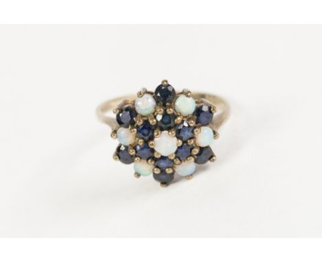 9ct GOLD, OPAL AND SAPPHIRE THREE TIER CIRCULAR CLUSTER RING, set with seven small opals and twelve small sapphires, 3.4gms 