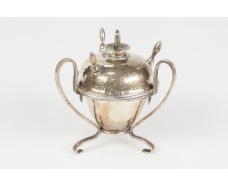 EDWARDIAN PLANISHED SILVER ACORN SHAPED TABLE CIGAR LIGHTER, on openwork stand with three 'S' scroll supports and fitted with