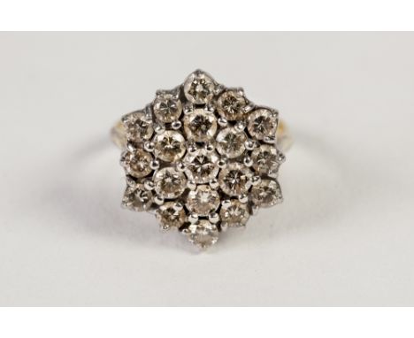 18ct GOLD AND DIAMOND CLUSTER RING, with a hexagonal cluster of nineteen small diamonds, in three tiers, 6.3gms, ring size K/