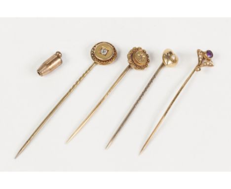 AN EDWARDIAN 14ct GOLD ART DECO STICK PIN, the fan shaped top set with an amethyst and  seed pearls; TWO EDWARDIAN STICK PINS