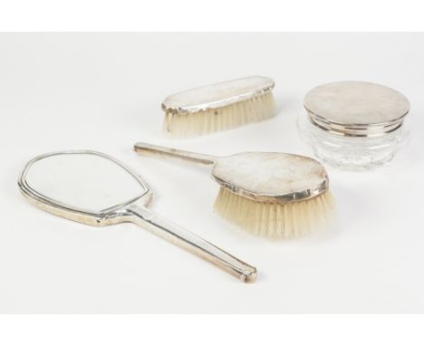 GEORGE VI ENGINE TURNED SILVER BACKED FOUR PIECE DRESSING TABLE SET, comprising: HAND MIRROR, TWO BRUSHES and a CUT GLASS BOX