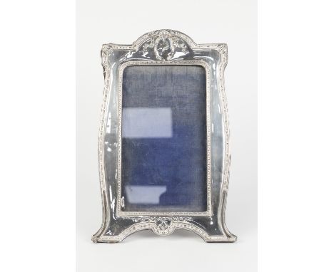 EARLY TWENTIETH CENTURY STAMPED SILVER FACED EASEL SUPPORT PHOTOGRAPH FRAME, of vertical form, with husk borders, Birmingham 