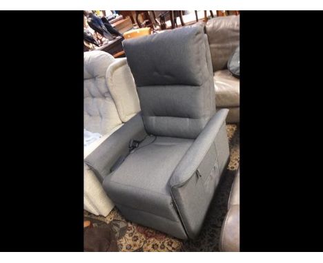 A modern electric reclining armchair in light grey material