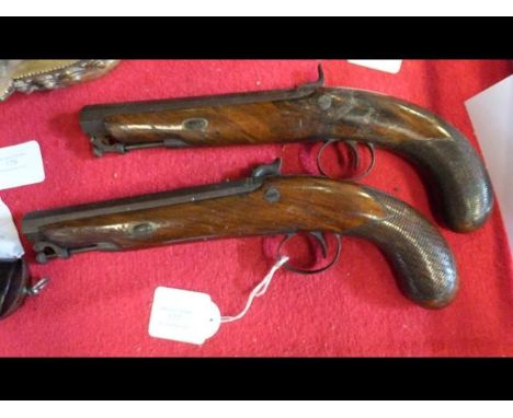 A pair of early 19th century dueling pistols, signed D. Egg, London, having octagonal barrels and measuring 32cms long, the b