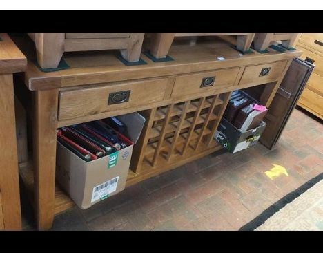 A modern light oak sideboard with three drawers to the front and wine rack beneath - 180cms