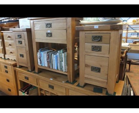 A pair of modern light oak three drawer bedside chests - height 70cms