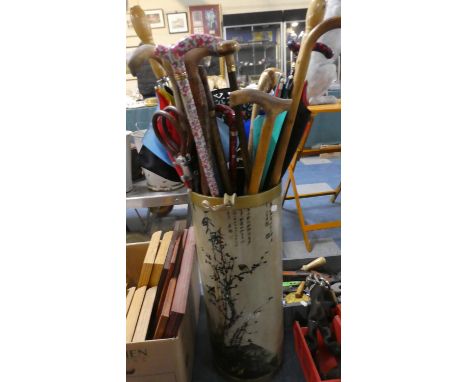 A Cylindrical Stick Stand with Oriental Decoration Containing Large Quantity of Walking Sticks and Umbrellas 