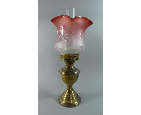 A Brass Oil Lamp with Coloured Glass Shade (Cracked) 