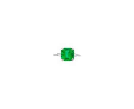 One emerald-cut emerald weighing 4.09 cts., 2 tapered baguette diamonds. Size 7 3/4. With AGL report no. 1144883 stating Colo