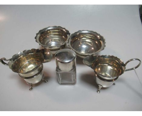 Two silver milk jugs, two silver sugar bowls and a silver topped glass cosmetics jar, 9.5ozt weighable silver