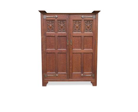 with carved and plain panelled doors, opening to reveal a mirror and stick stand to one and hanging space within, applied cop